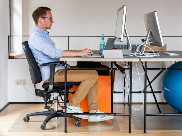 Image showing one of our colleagues working in front of his desktop