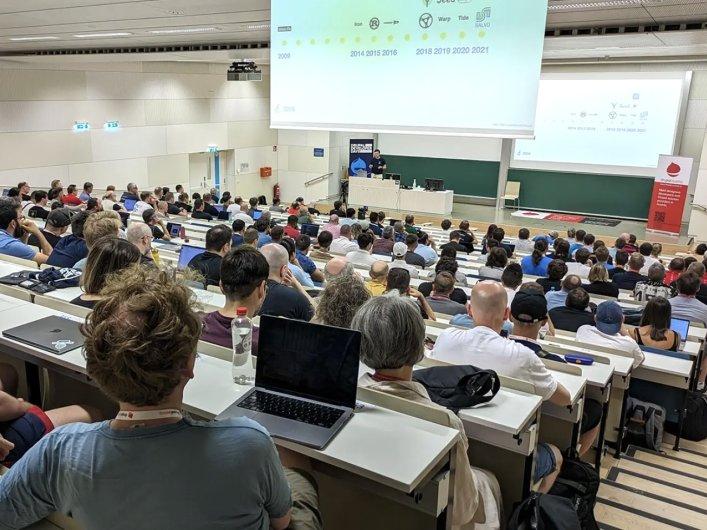 Participants engaged in conversation during a lecture session at the Drupal Developer Days 2023 in Vienna, Austria.
