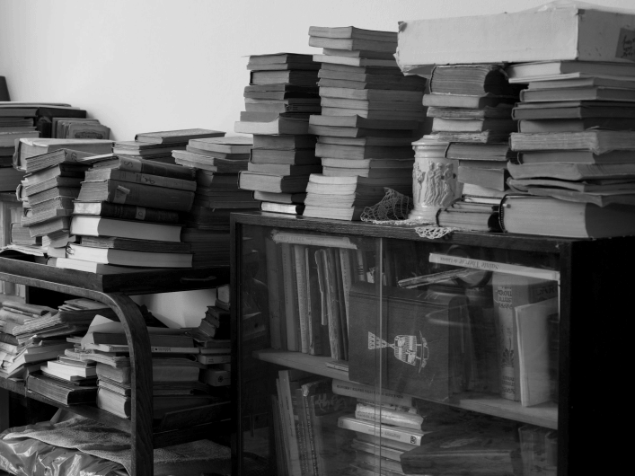Unstrukturierte Wissensablage mit Papierstapeln auf Schreibtisch – symbolische Herausforderung ohne Learning Content Management System im Digitalumfeld.