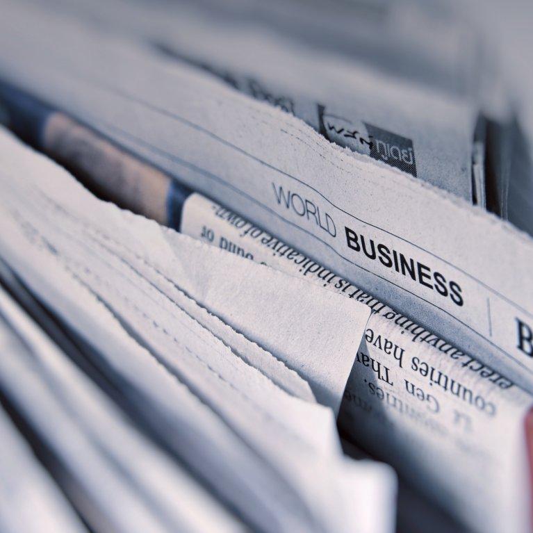 Several newspapers arranged horizontally