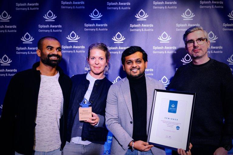 Winning team from Factorial holding up their Splash Award and certification at Splash Awards Germany and Austria 2023 at Manufaktur Mannheim, Germany.