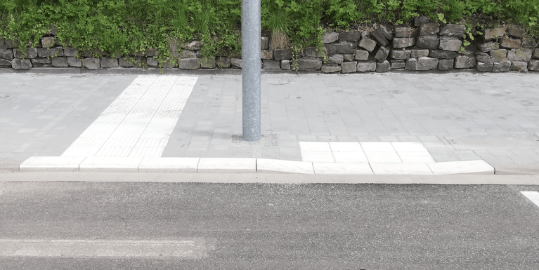 Curb cut with tactical paving to cross street with a wheelchair