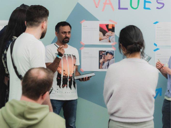A group of people in the Factorial office, discussing team values and collaboration.