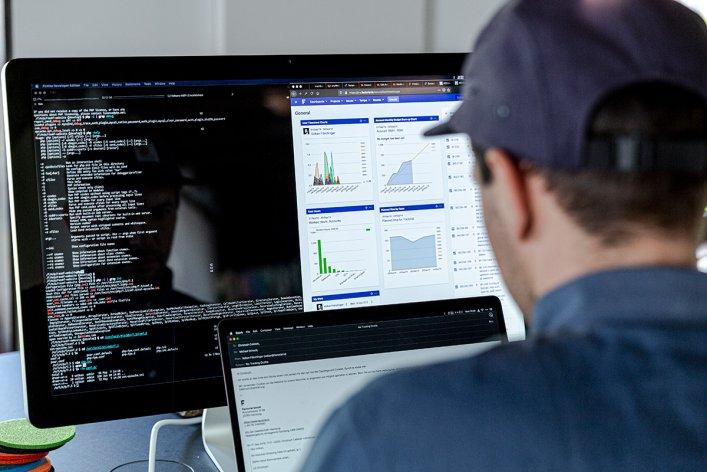 Mitarbeitender am Schreibtisch bei der Arbeit im Bereich Software-Entwicklung.